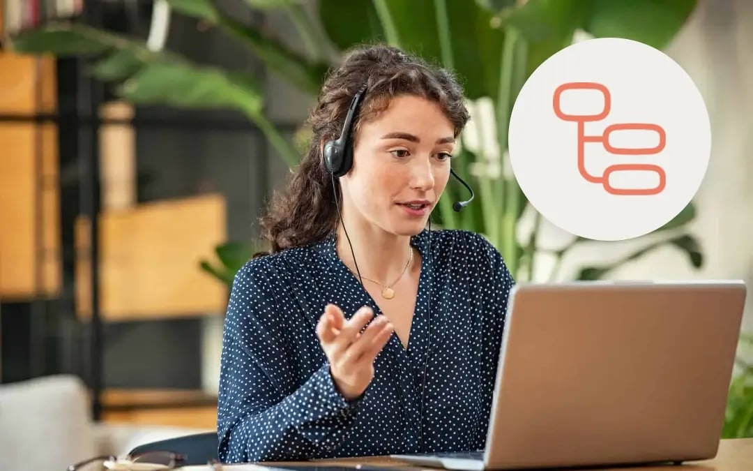 Agent wearing headset on video call in bright office environment with red data branching icon