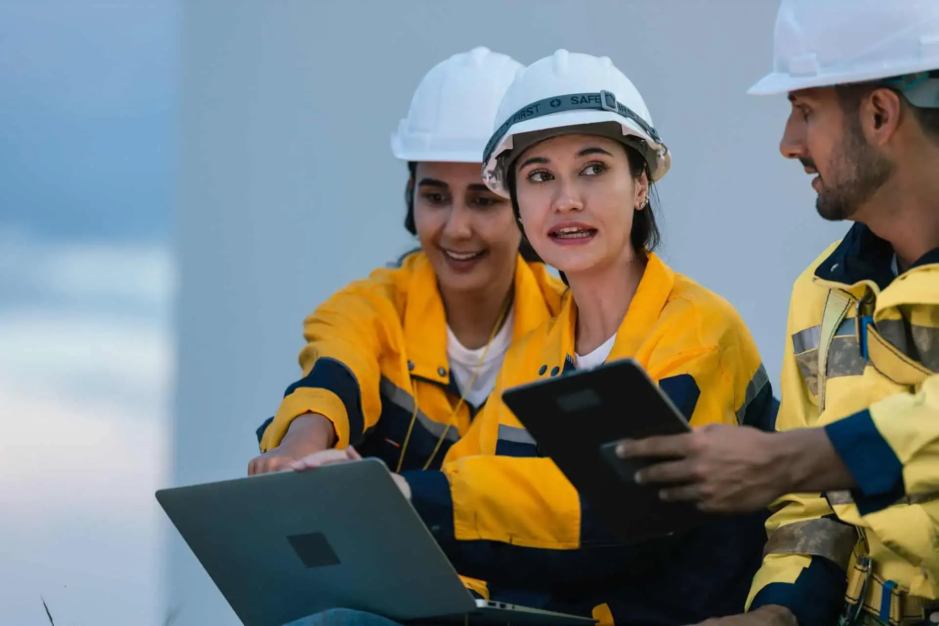 Construction team using a laptop on site