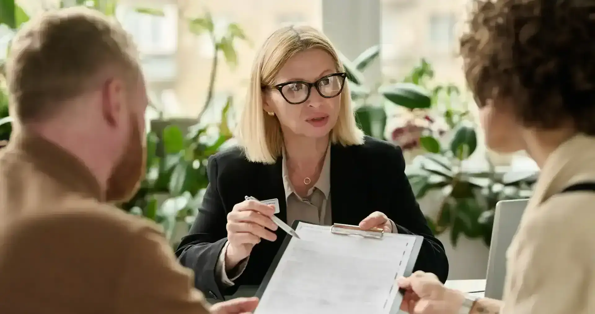 Finance professional explaining a document to two customers