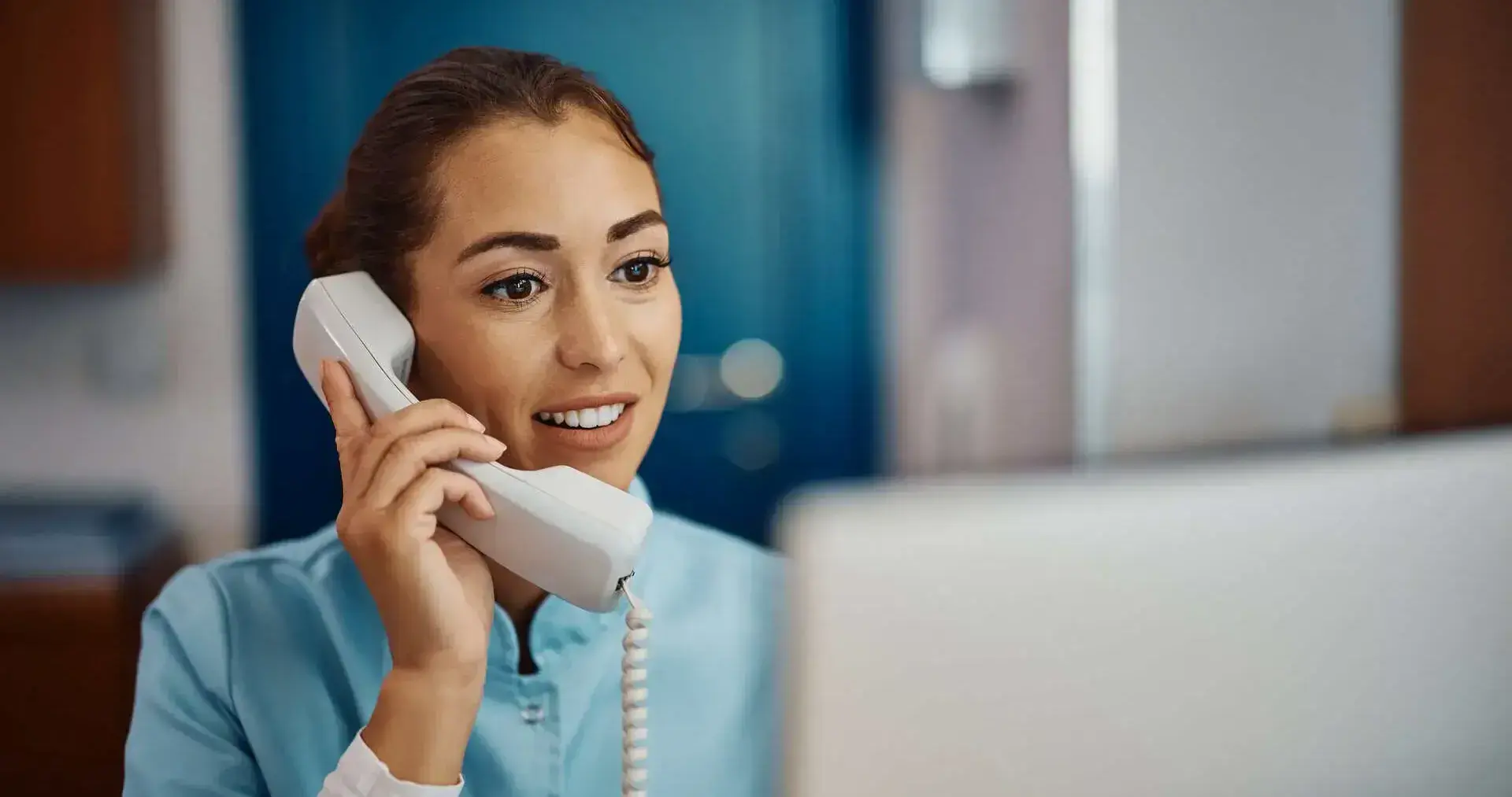 Healthcare worker using the phone at desk