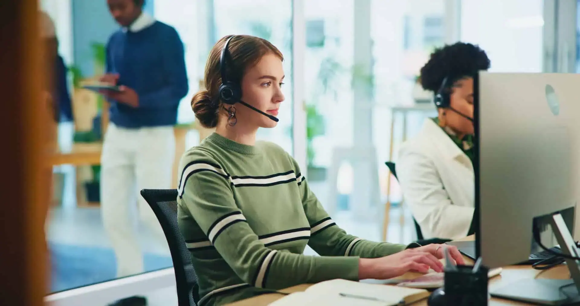 Call center agent working in a busy office