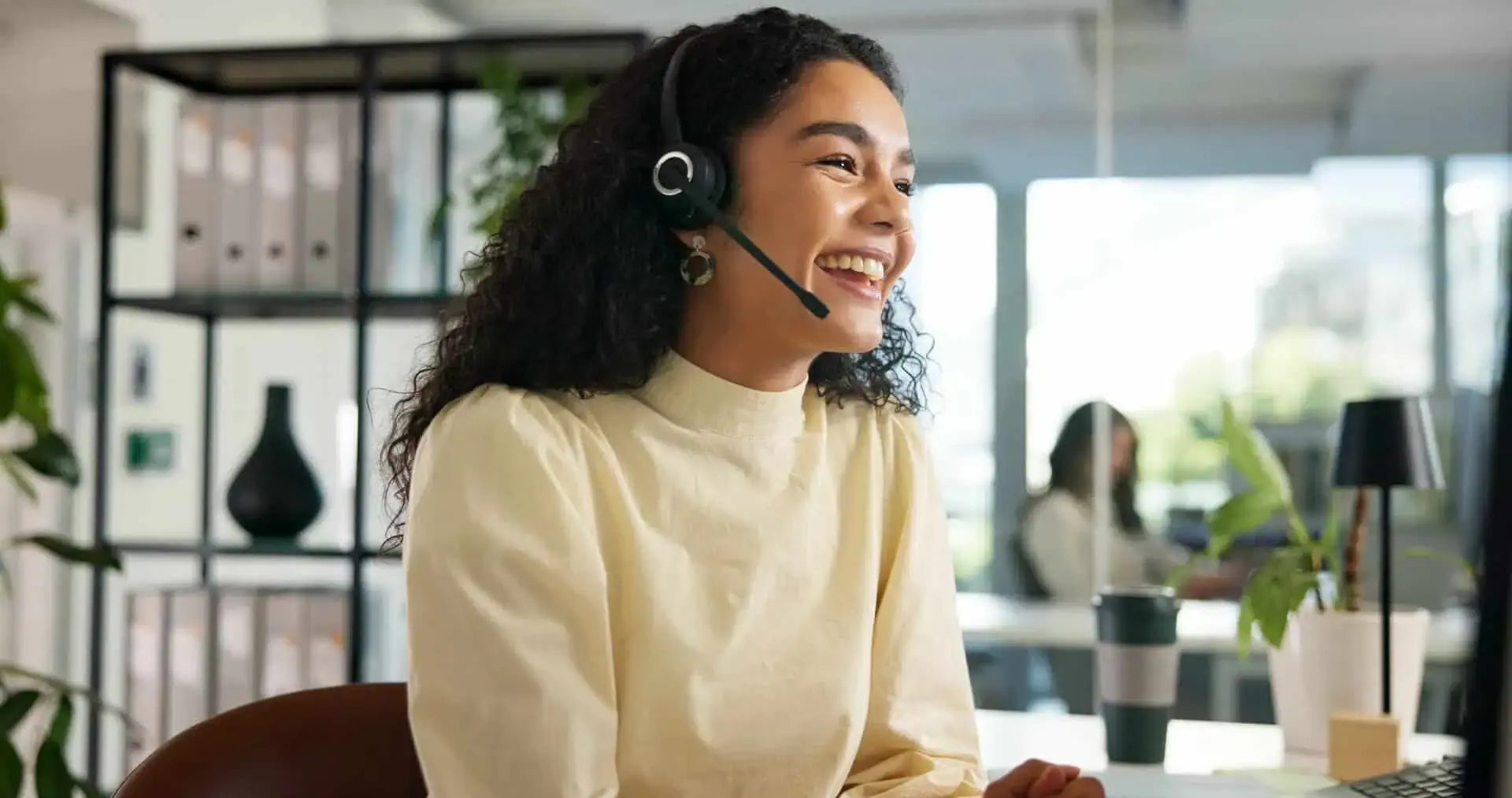 Cheerful contact center agent working with a headset