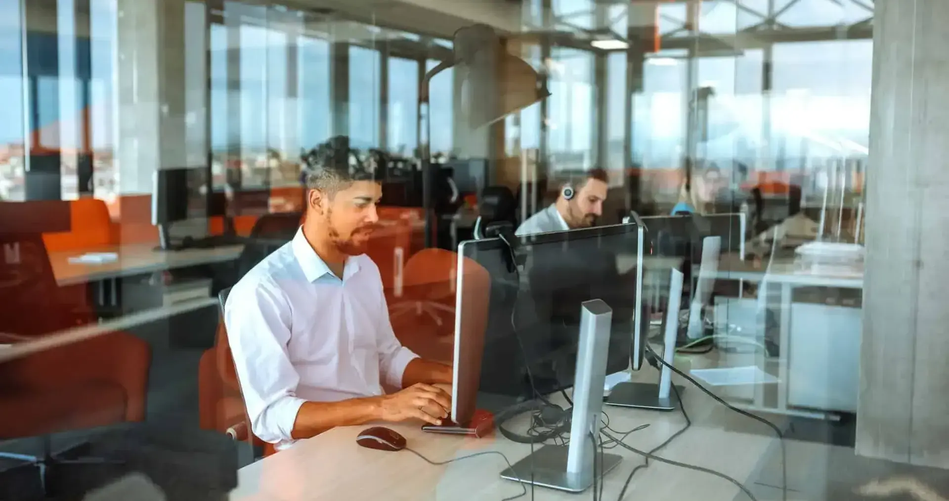 Contact center agents sitting at their desks working on computers