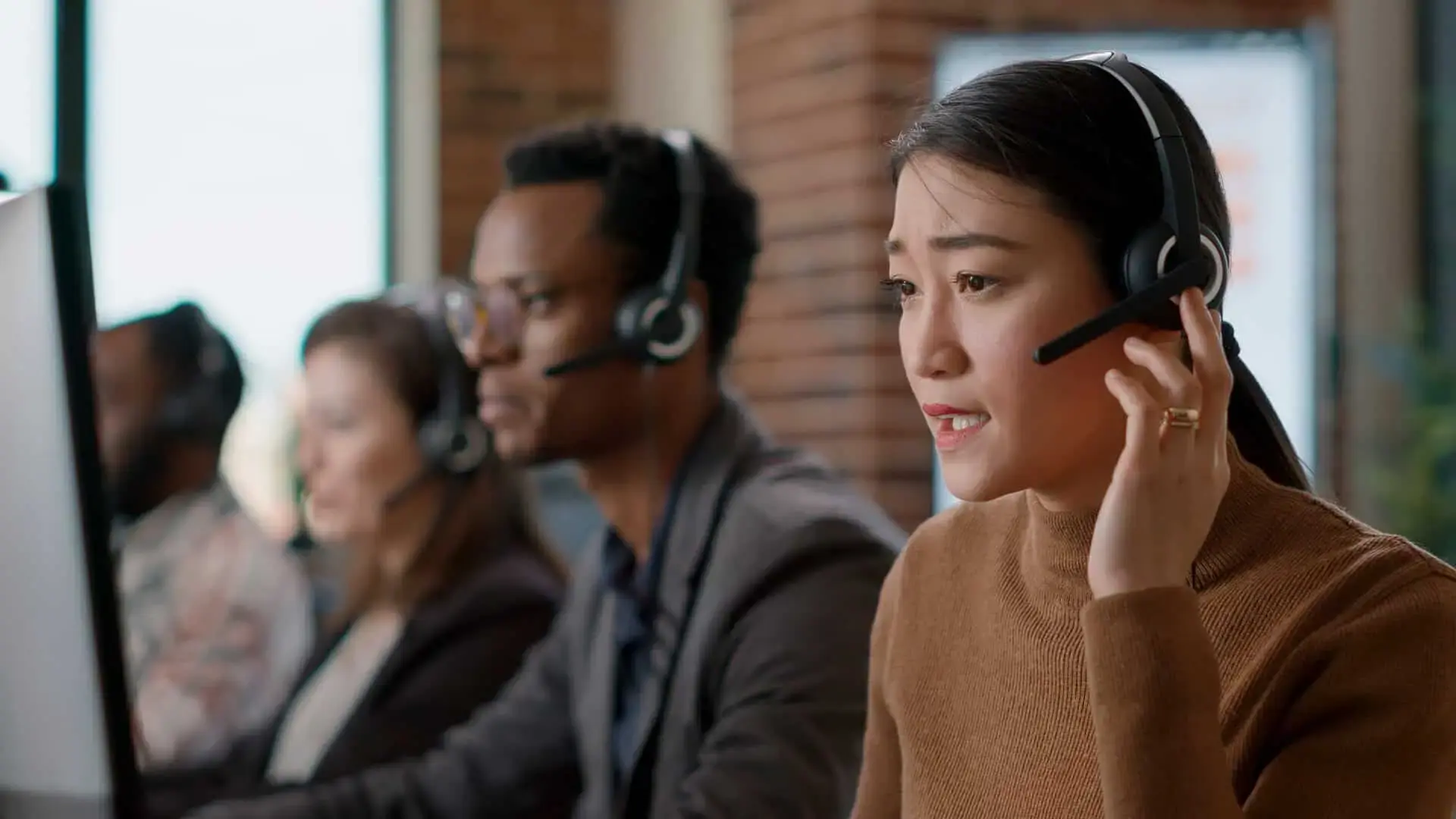 Contact center team wearing headsets at their workstations
