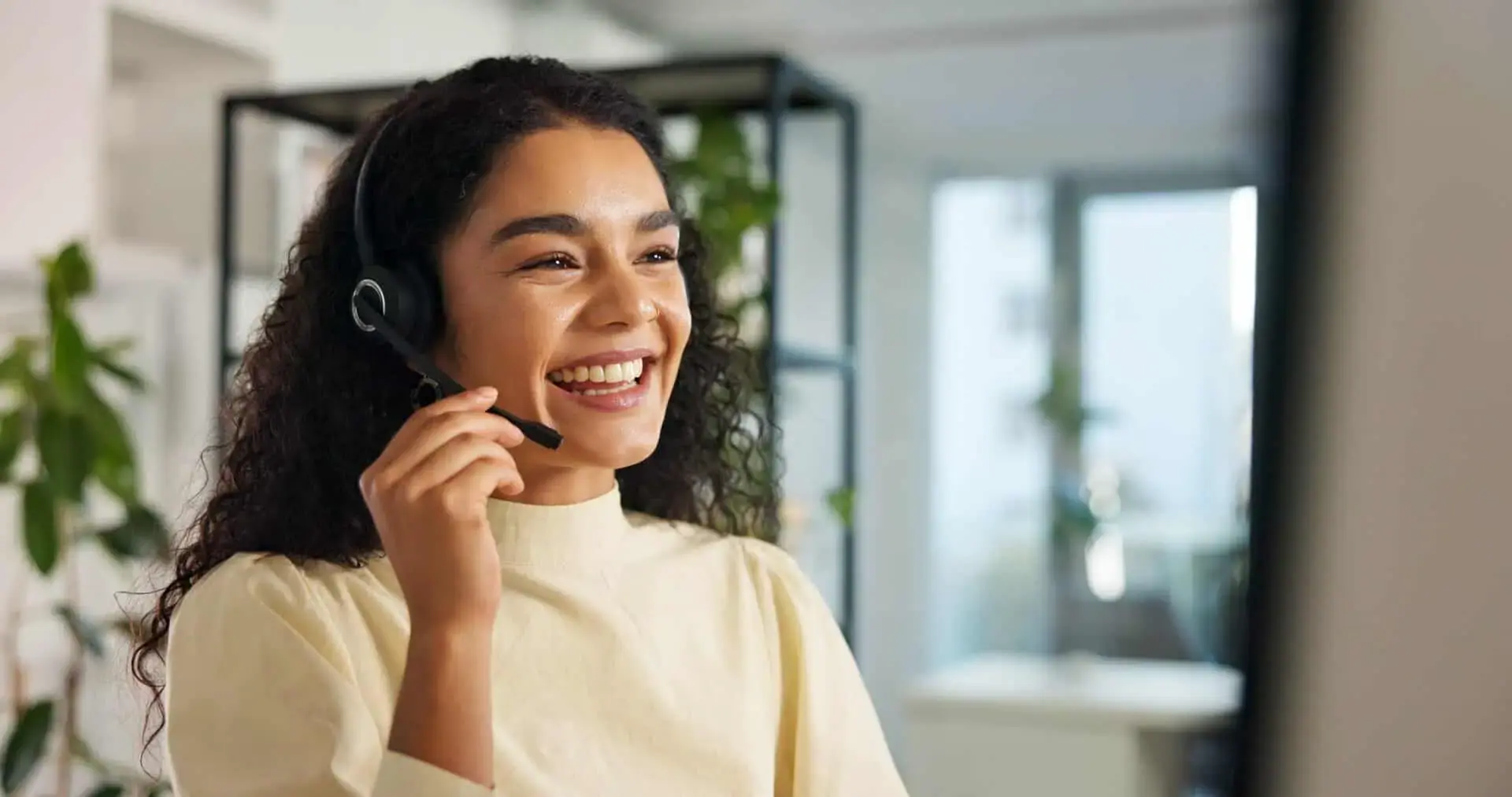 Smiling contact center professional at their workstation