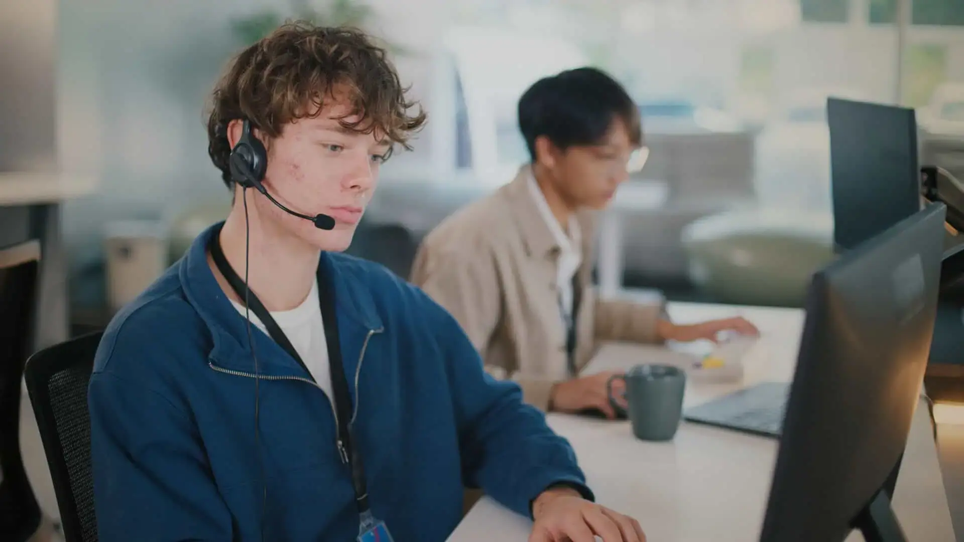 Young contact center agent focused on a call