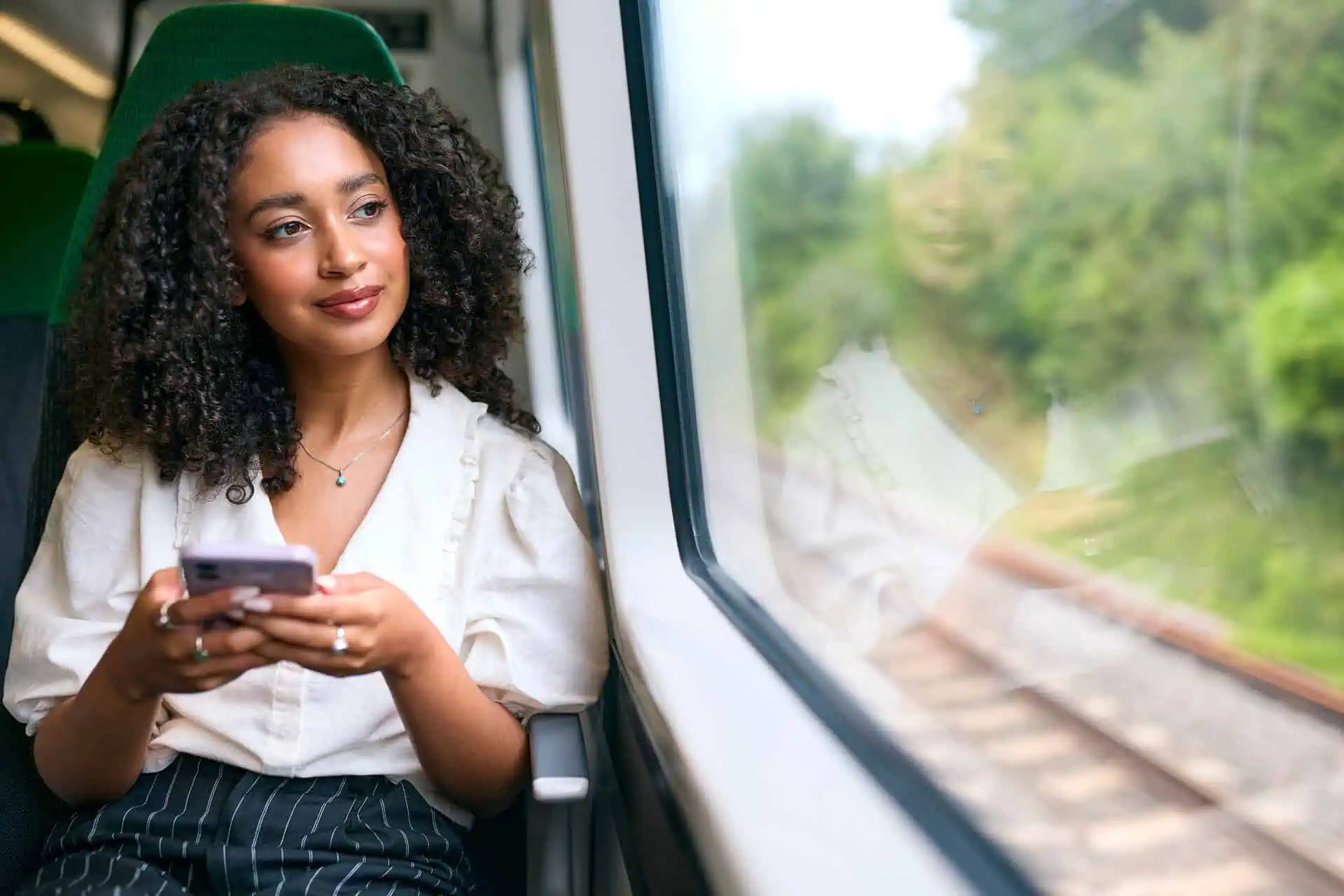 Professional using their phone while commuting on a train