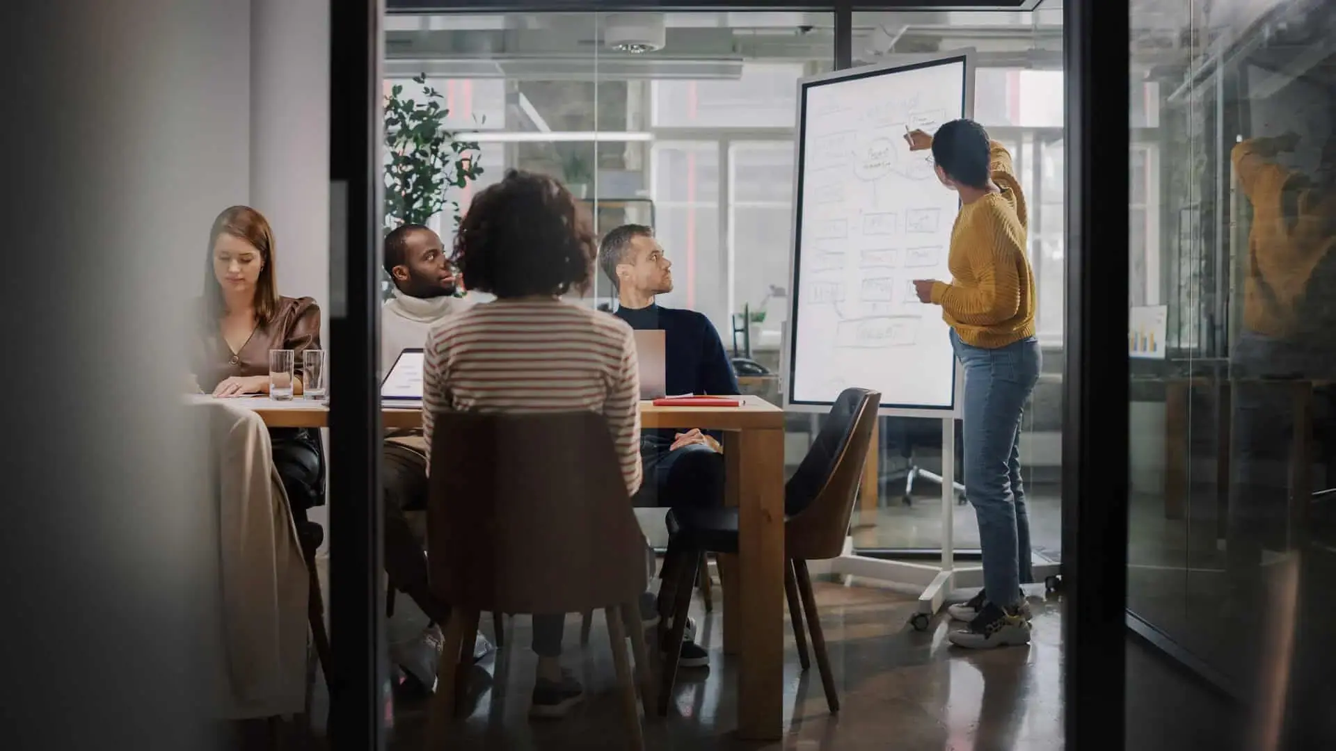 Manager presenting to a team in a meeting room