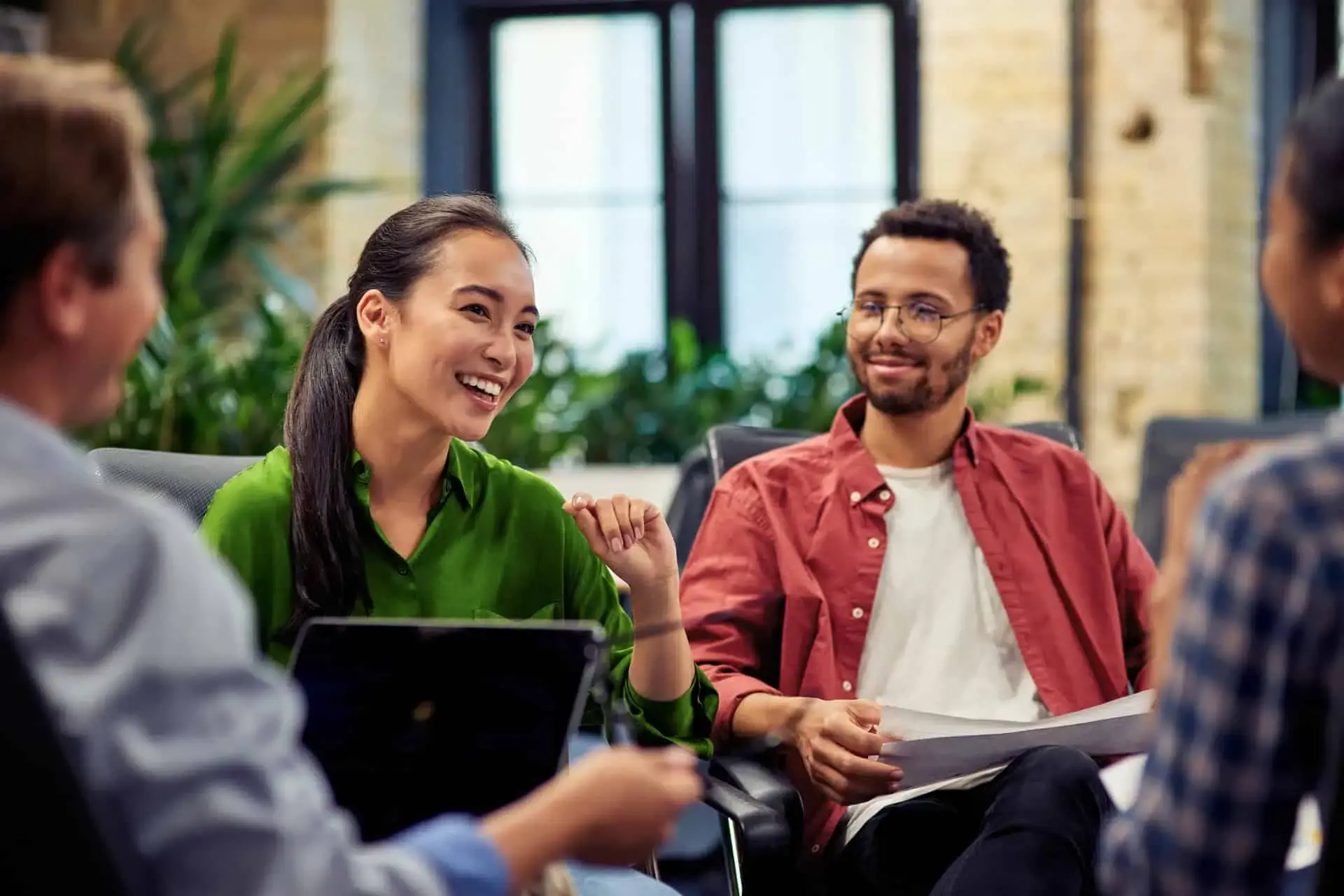 Team in a meeting discussing using a tablet