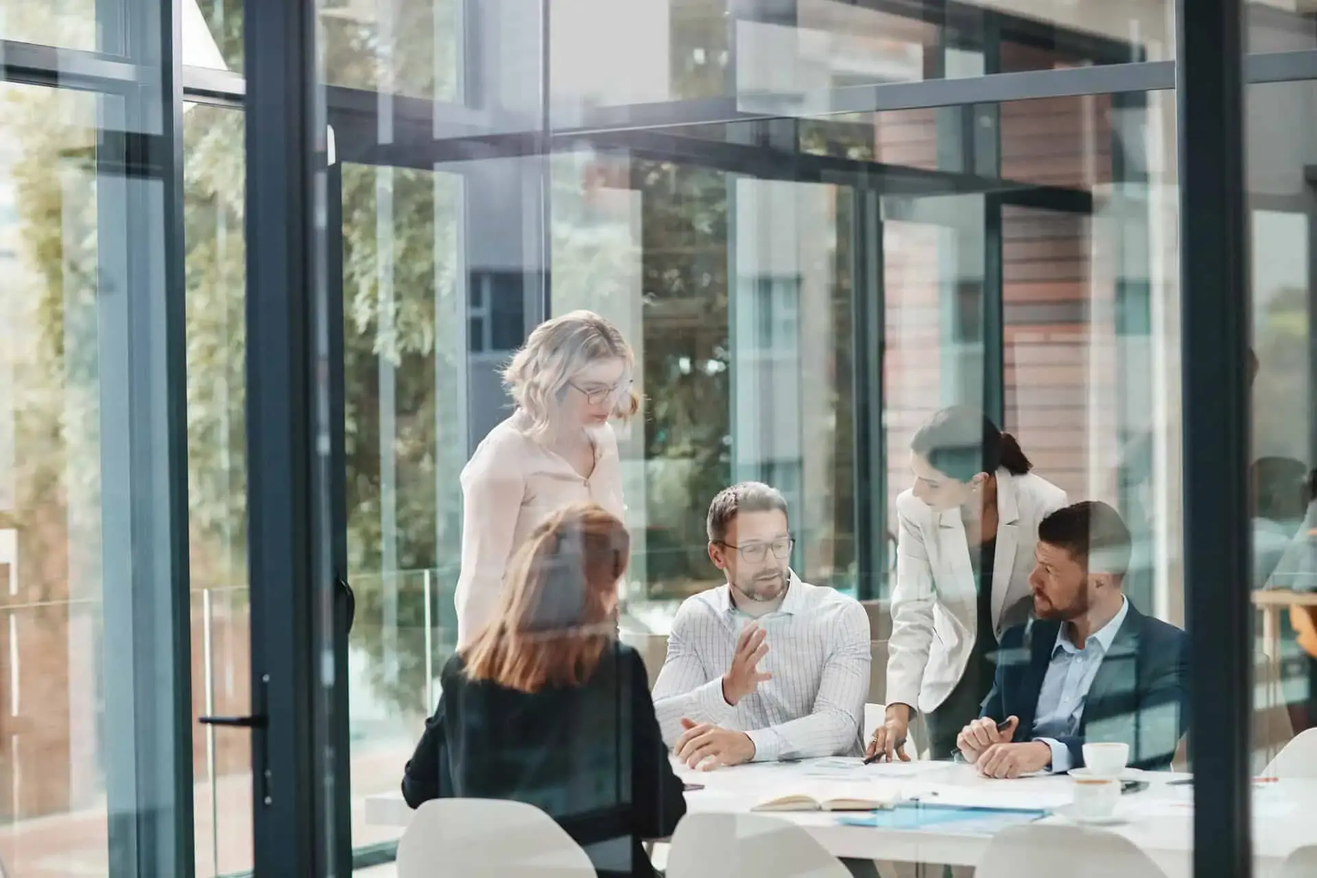 Team meeting in a modern glass-walled office